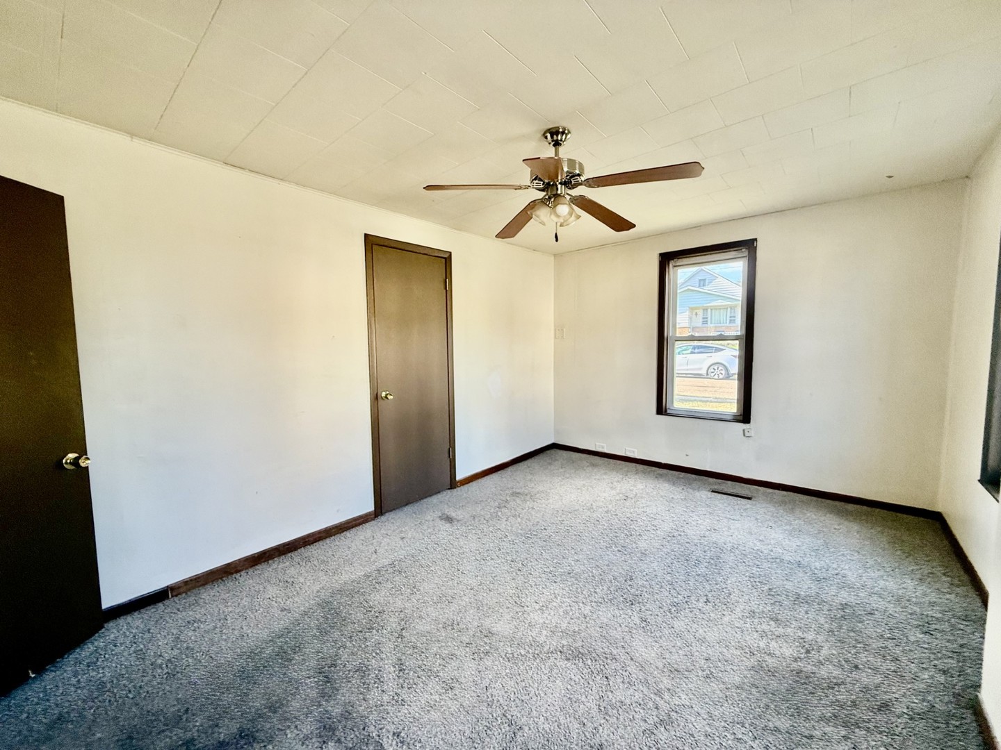 2302 1st Street Peru, IL 61354 - Photo 8 of 22 an empty room with windows and fan