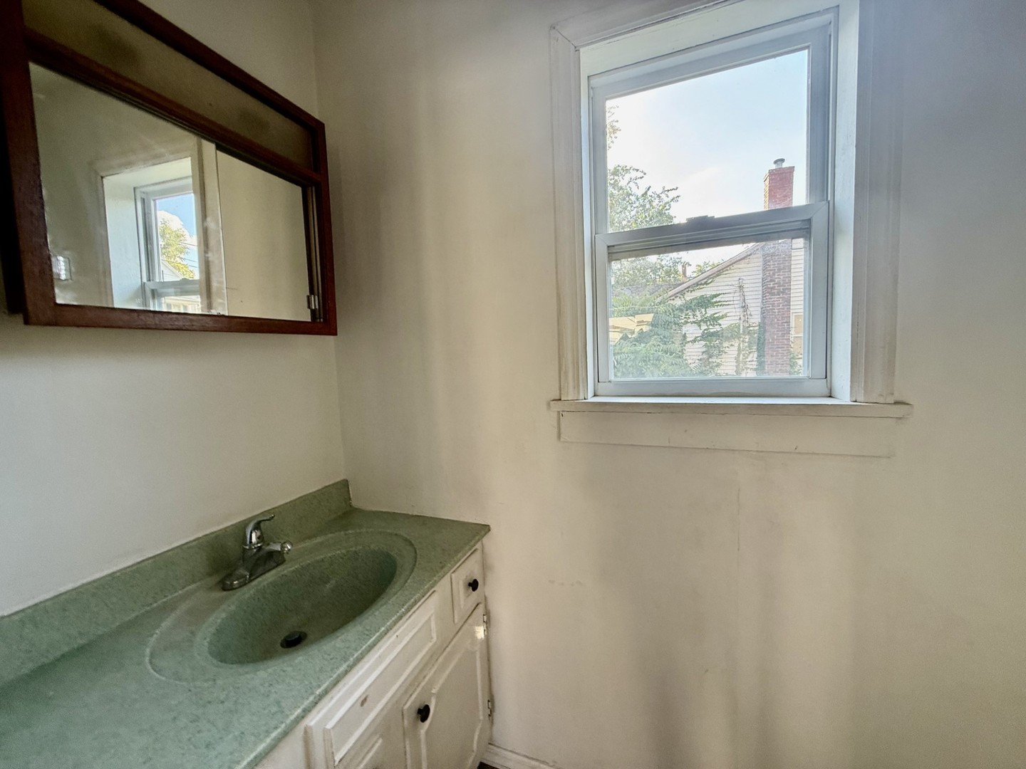 2302 1st Street Peru, IL 61354 - Photo 9 of 22 a bathroom with a sink a vanity and mirror