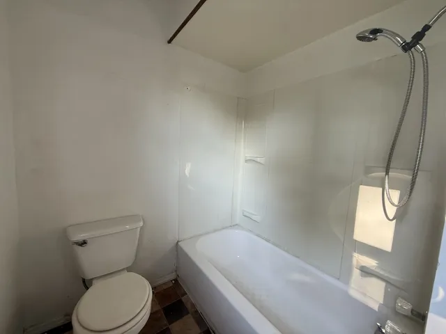 a bathroom with a toilet and bathtub