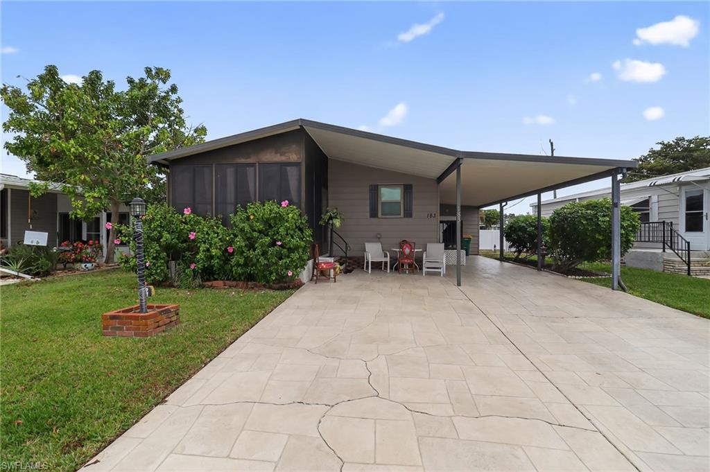 a view of a backyard with sitting area