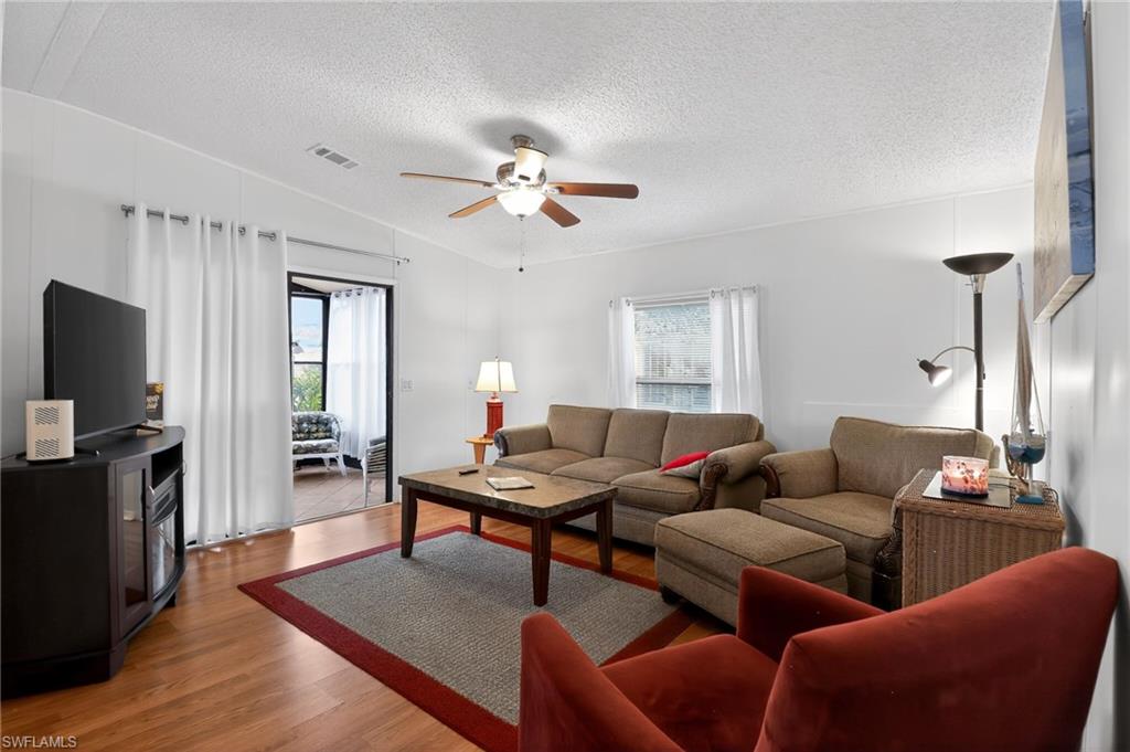183 Oceans Boulevard, Unit 183 Naples, FL 34104 - Photo 16 of 28 Living area featuring wood finished floors, plenty of natural light, and a ceiling fan