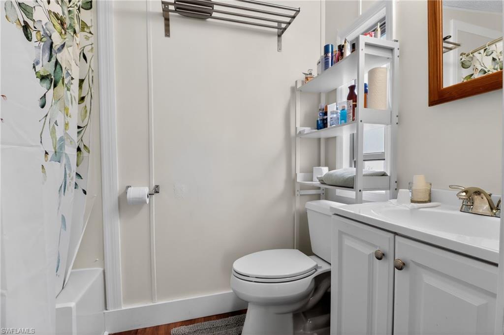 183 Oceans Boulevard, Unit 183 Naples, FL 34104 - Photo 19 of 28 Bathroom featuring vanity and shower / bath combination with curtain