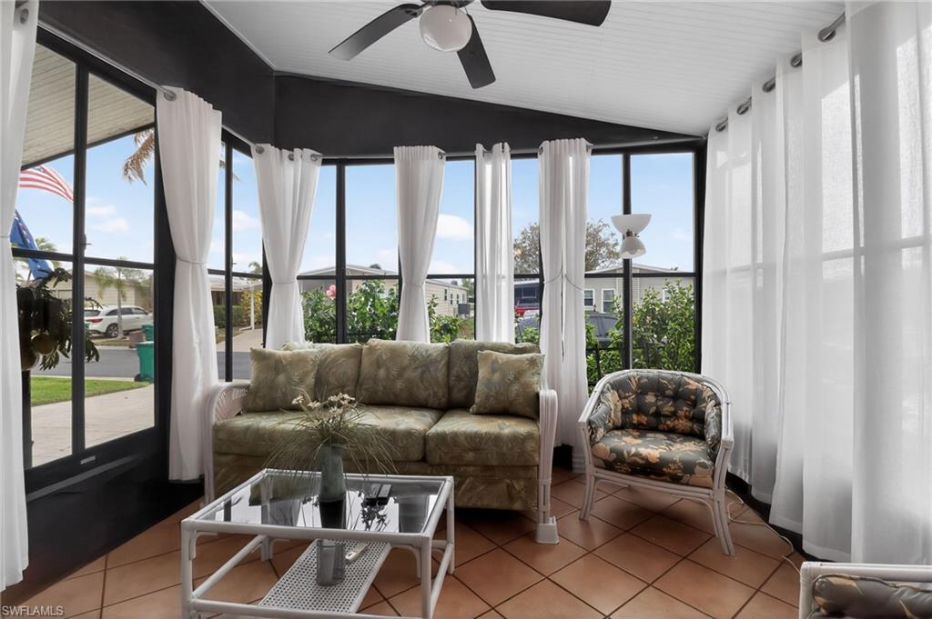 183 Oceans Boulevard, Unit 183 Naples, FL 34104 - Photo 25 of 28 Sunroom with tile patterned floors and lofted ceiling