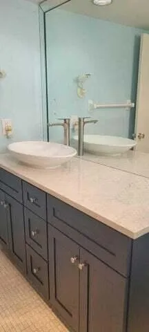 a bathroom with a double vanity sink and a mirror