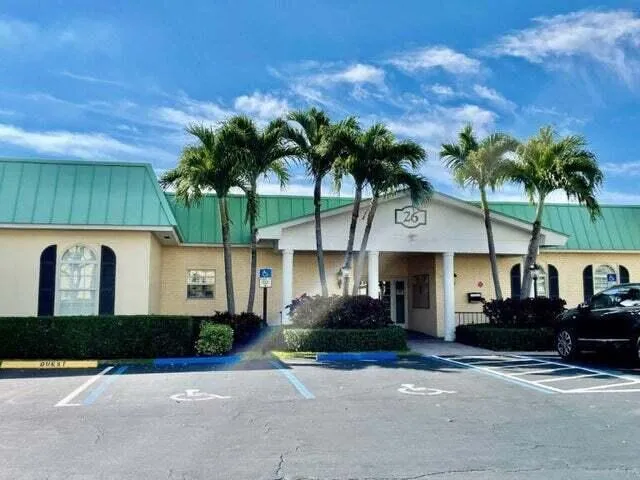 a living room with lots of furniture and a wooden floor