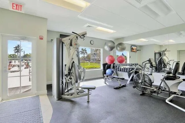 a room with pool table and windows
