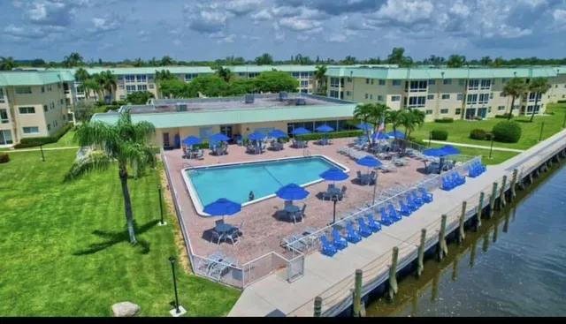 a view of swimming pool with outdoor seating and lake view