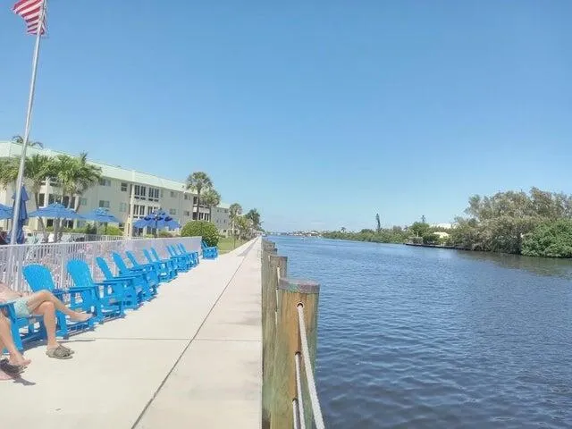 a view of a swimming pool with a patio and a lake view
