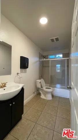 a bathroom with a sink a toilet and mirror