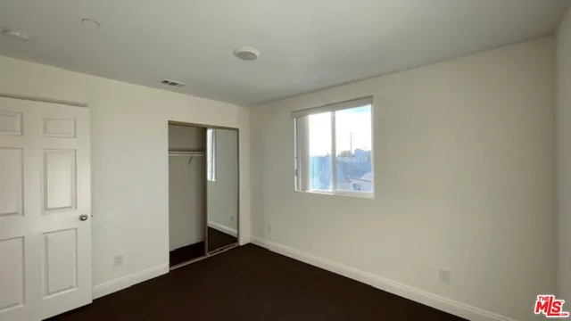a view of an empty room and a window