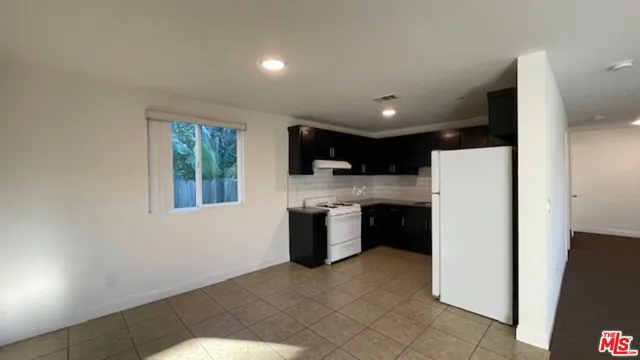 a kitchen with a refrigerator a stove top oven a sink and dishwasher