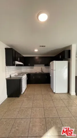 a large kitchen with stainless steel appliances and cabinets