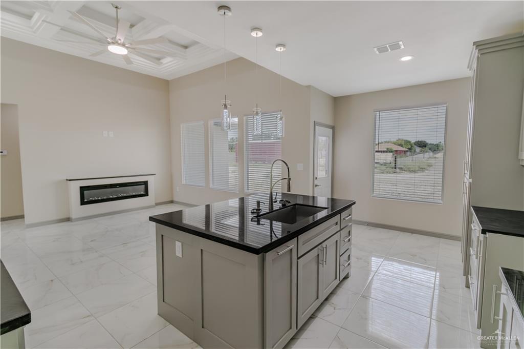 216 Nazareth Street Rio Grande City, TX 78582 - Photo 2 of 14 a kitchen with stainless steel appliances granite countertop a sink and a refrigerator