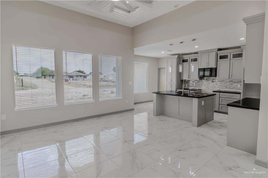 216 Nazareth Street Rio Grande City, TX 78582 - Photo 3 of 14 a kitchen with stainless steel appliances kitchen island granite countertop a stove and a sink
