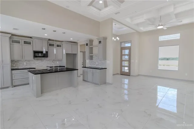 a kitchen with stainless steel appliances granite countertop a refrigerator and a stove top oven