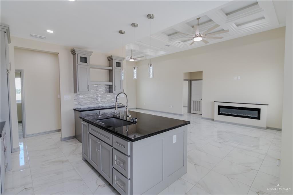 216 Nazareth Street Rio Grande City, TX 78582 - Photo 6 of 14 a kitchen with stainless steel appliances granite countertop a sink and a refrigerator