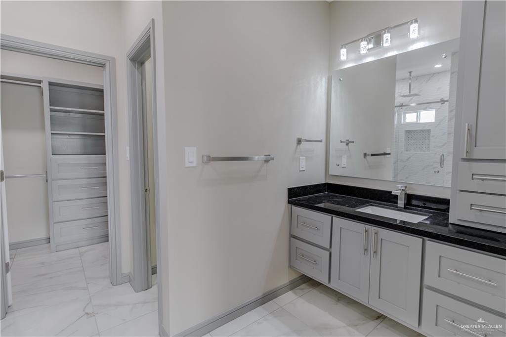 216 Nazareth Street Rio Grande City, TX 78582 - Photo 8 of 14 a kitchen with granite countertop a sink and cabinets