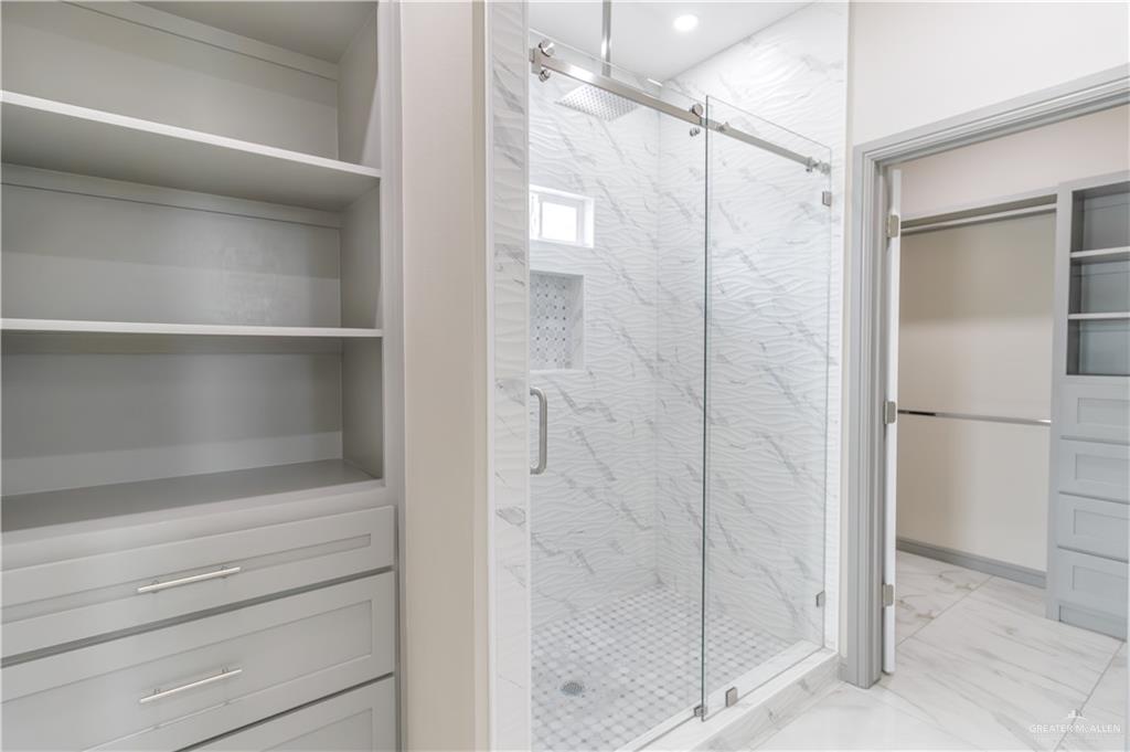 216 Nazareth Street Rio Grande City, TX 78582 - Photo 9 of 14 a bathroom with a shower and a glass door