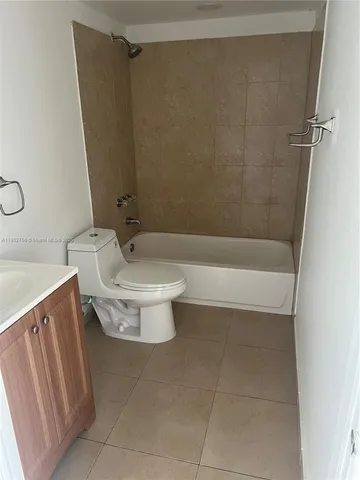 a bathroom with a sink a toilet and bathtub