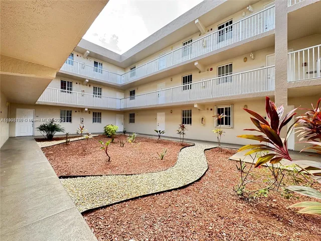 swimming pool view with couple of cars parked in front of it