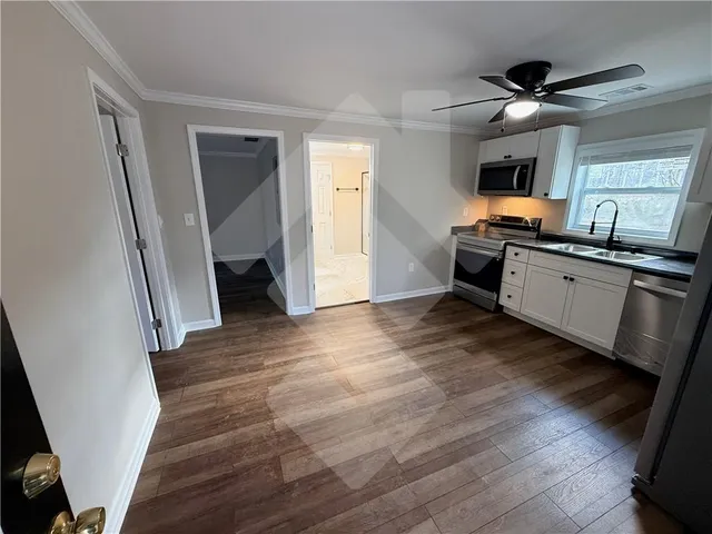 a view of kitchen with sink microwave and refrigerator