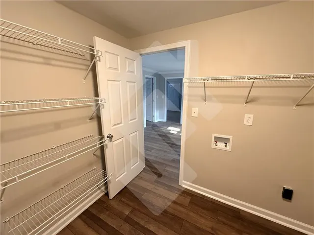 a living room with a black white checkered floor with a large window