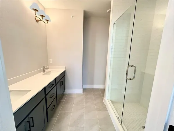 a bathroom with a double vanity sink and mirror