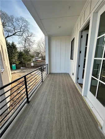 a view of a balcony with wooden floor