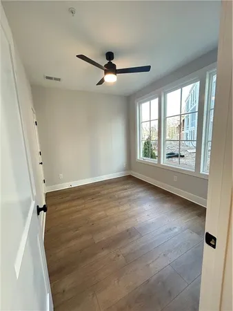 wooden floor in an empty room with a window