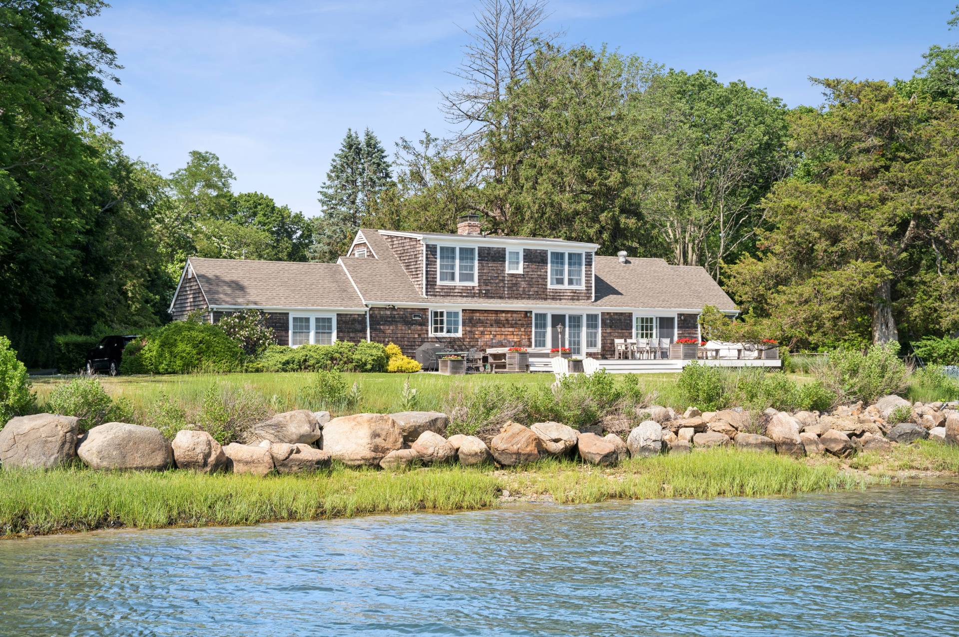 69 Ferry Road Sag Harbor, NY 11963 - Photo 3 of 17 a front view of a house with a yard and potted plants