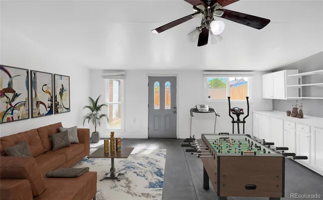 a living room with furniture and wooden floor