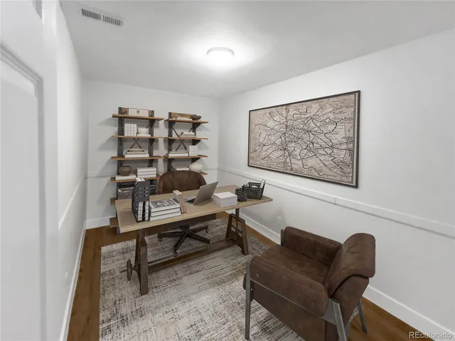 a view of a livingroom with workspace and a couch