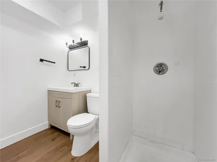 a bathroom with a toilet a sink and mirror