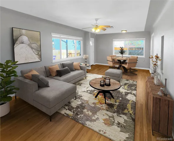 a living room with furniture and a wooden floor