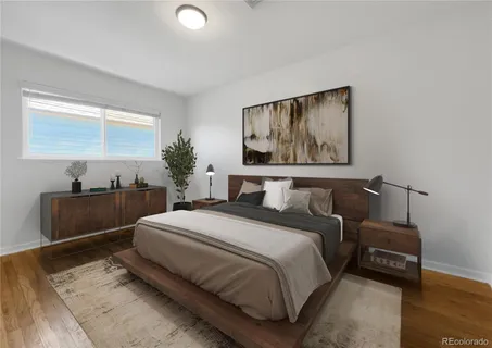 a spacious bedroom with a bed and a couch