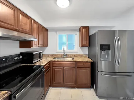 a kitchen with a sink stove and refrigerator
