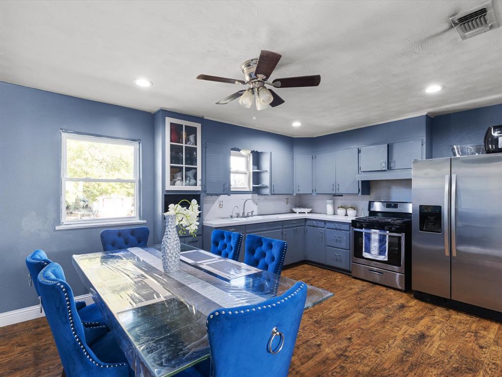 1805 Stevens Street Bridgeport, TX 76426 - Photo 9 of 24 a kitchen with sink refrigerator dining table and chairs