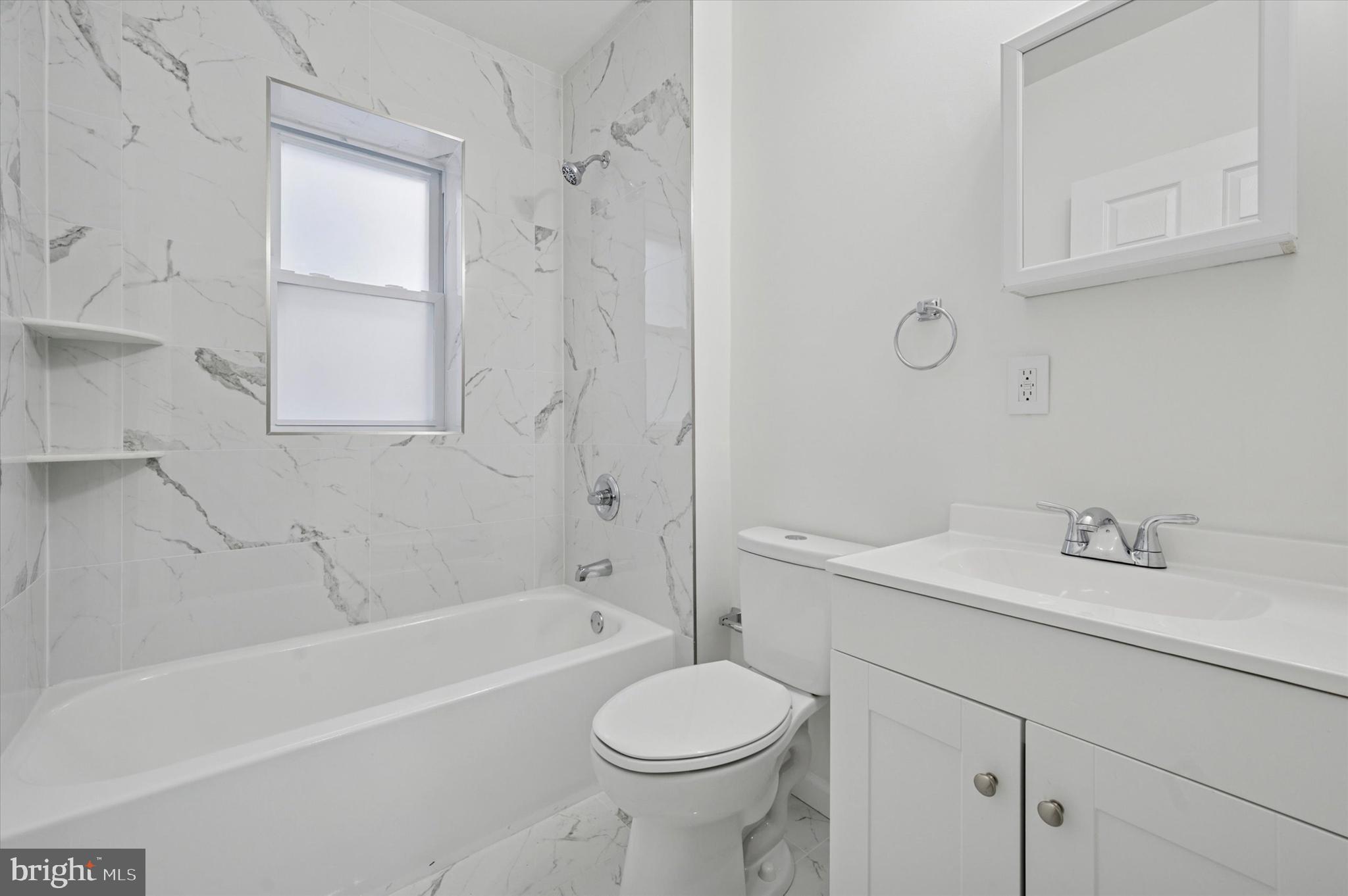 5431 Walnut Street, Unit 2 Philadelphia, PA 19139 - Photo 6 of 6 a bathroom with a sink toilet vanity and bathtub