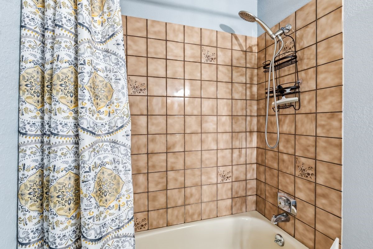 89410 Ryan Gulch Road, Unit 208 Silverthorne, CO 80498 - Photo 17 of 30 a bathroom with a bathtub and shower