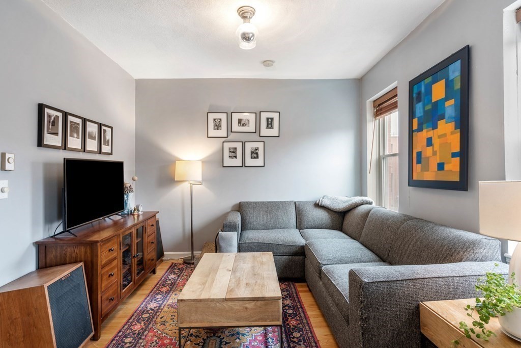 136 Prince Street, Unit 6 Boston, MA 02113 - Photo 4 of 14 a living room with furniture and a flat screen tv