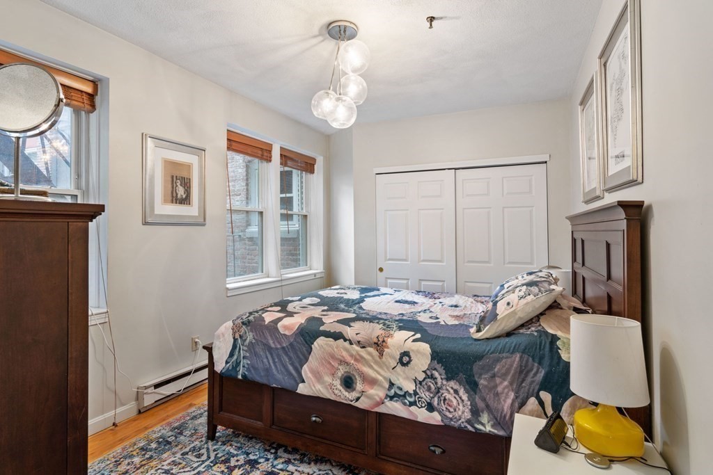 136 Prince Street, Unit 6 Boston, MA 02113 - Photo 5 of 14 a bedroom with bed and wooden floor