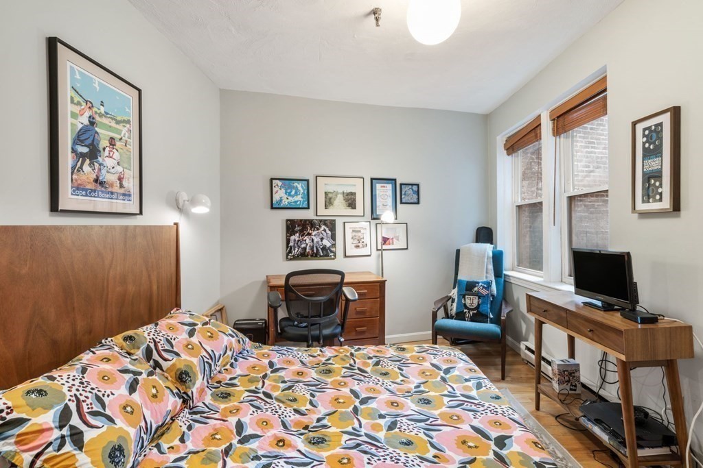 136 Prince Street, Unit 6 Boston, MA 02113 - Photo 10 of 14 a bedroom with a bed and wooden floor