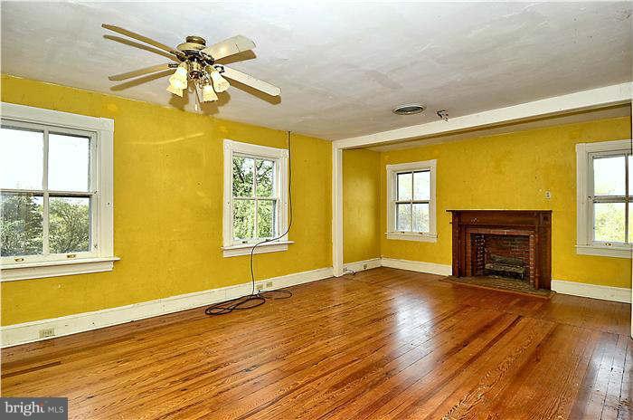3653 Point Of Rocks Road Jefferson, MD 21755 - Photo 5 of 27 a view of empty room with a fireplace and wooden floor