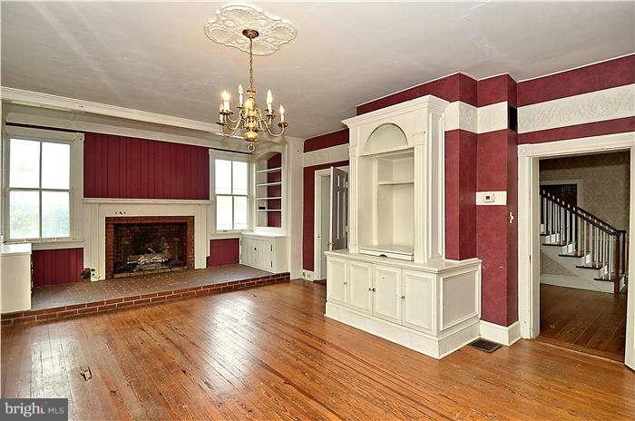 3653 Point Of Rocks Road Jefferson, MD 21755 - Photo 6 of 27 a view of a livingroom with a fireplace wooden floor and windows