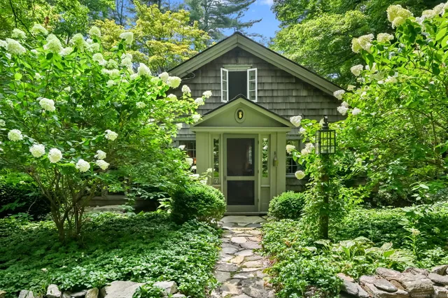 a front view of a house with plants
