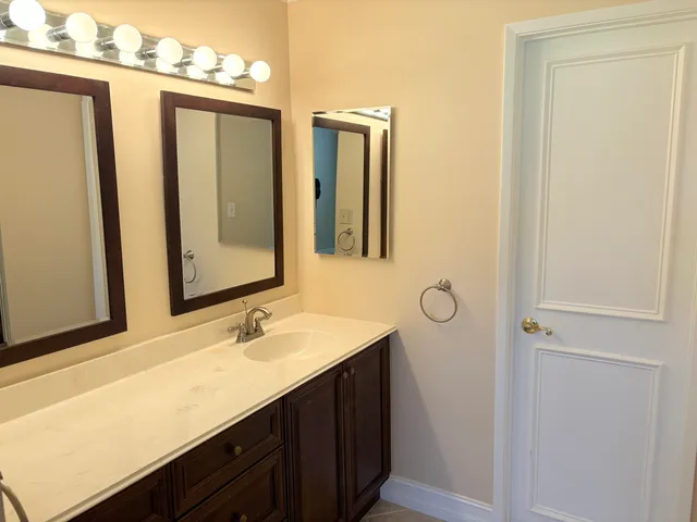 a bathroom with a sink vanity and a mirror