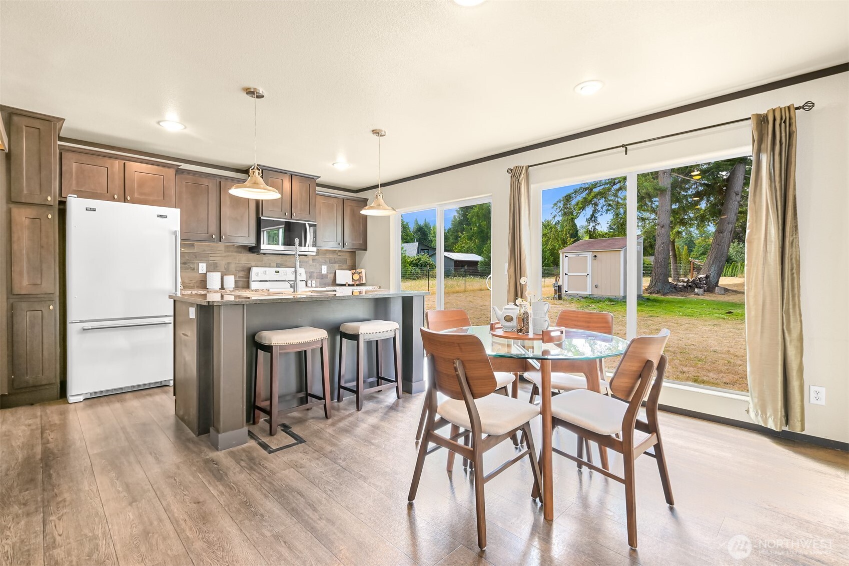 1229 West Axton Road Ferndale, WA 98248 - Photo 15 of 40 a kitchen with a table chairs refrigerator and microwave