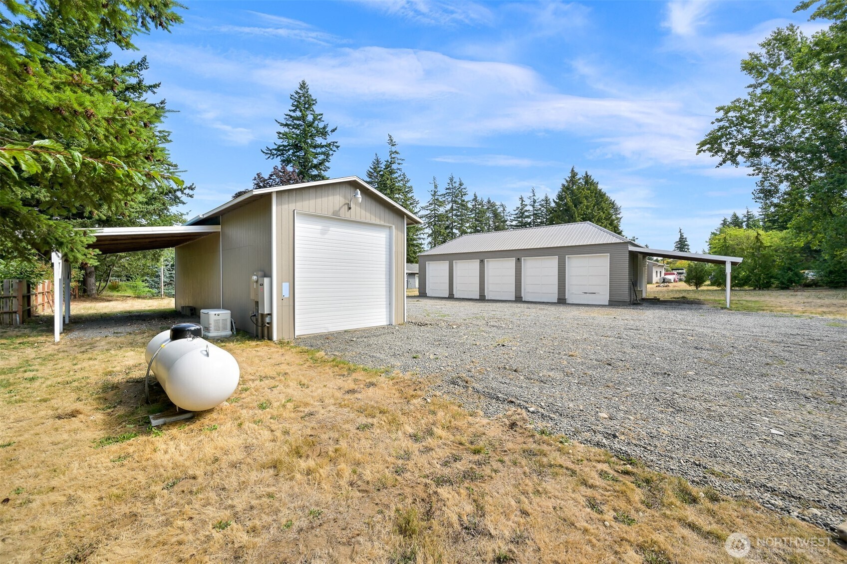 1229 West Axton Road Ferndale, WA 98248 - Photo 31 of 40 a white house with a yard and garden