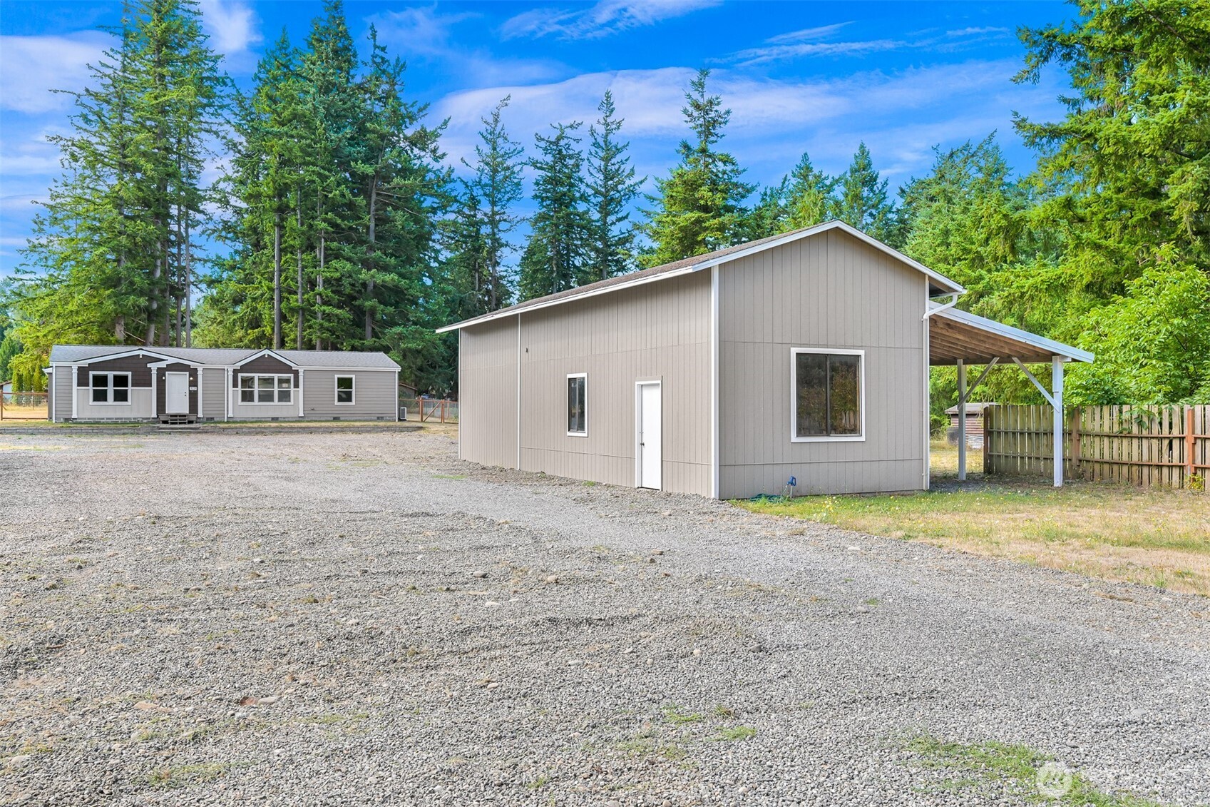 1229 West Axton Road Ferndale, WA 98248 - Photo 34 of 40 a view of a house with backyard and trees in the background