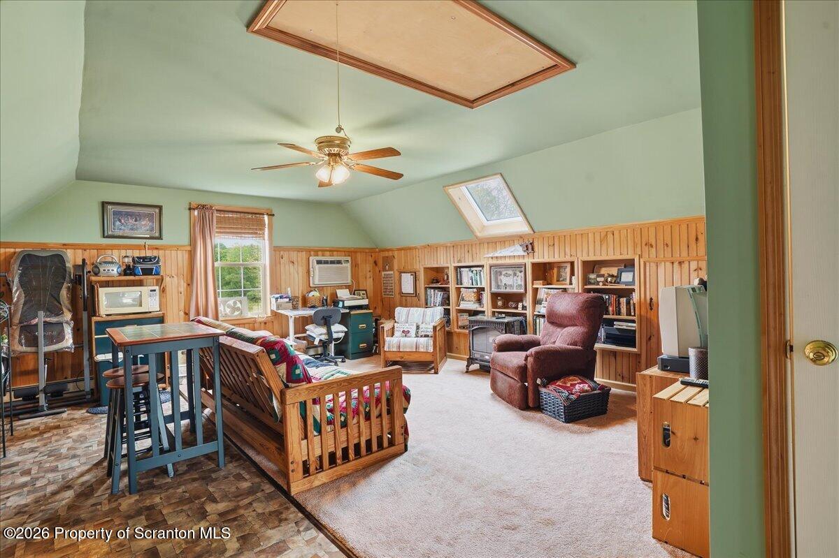 5231 Fiddle Lake Road Thompson, PA 18465 - Photo 15 of 34 a living room with furniture a chandelier and a large window